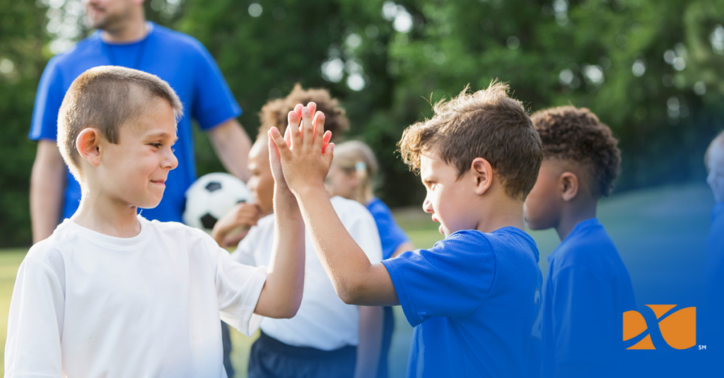 child high-fiving opposing team