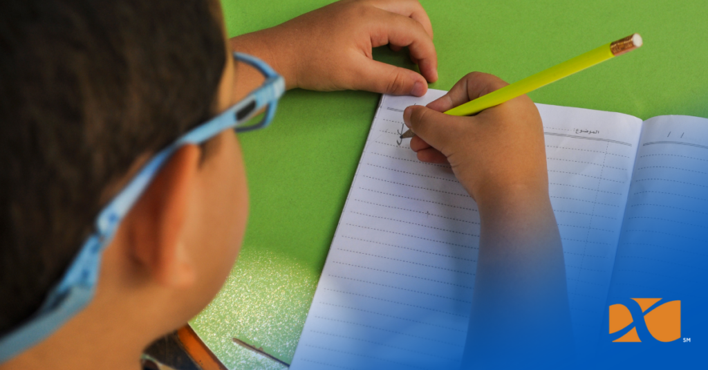 child writing down list of pins to collect